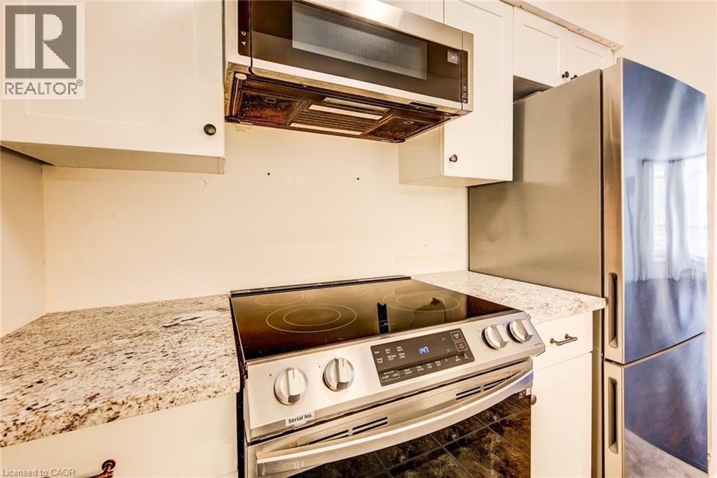 Slim microwave and stainless appliances are included - 1414 King Street E Unit# 101, Kitchener, ON - Indoor Photo Showing Kitchen