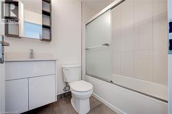 Contemporary bathroom featuring a white vanity with integrated sink, chrome faucet, and a wall-mounted mirrored medicine cabinet with open shelving -