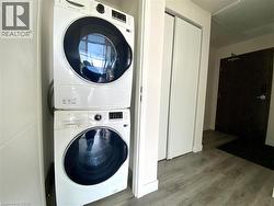 Stacked white front-loading washer and dryer units -