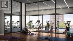 Dedicated fitness center featuring wood-finish flooring, extensive floor-to-ceiling windows, and recessed linear lighting -