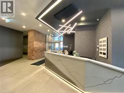 Lobby featuring a reception desk with a decorative front panel and integrated lighting -