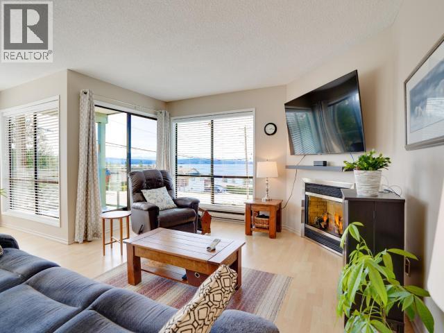 8-3818 Joyce Ave, Powell River, BC - Indoor Photo Showing Living Room With Fireplace