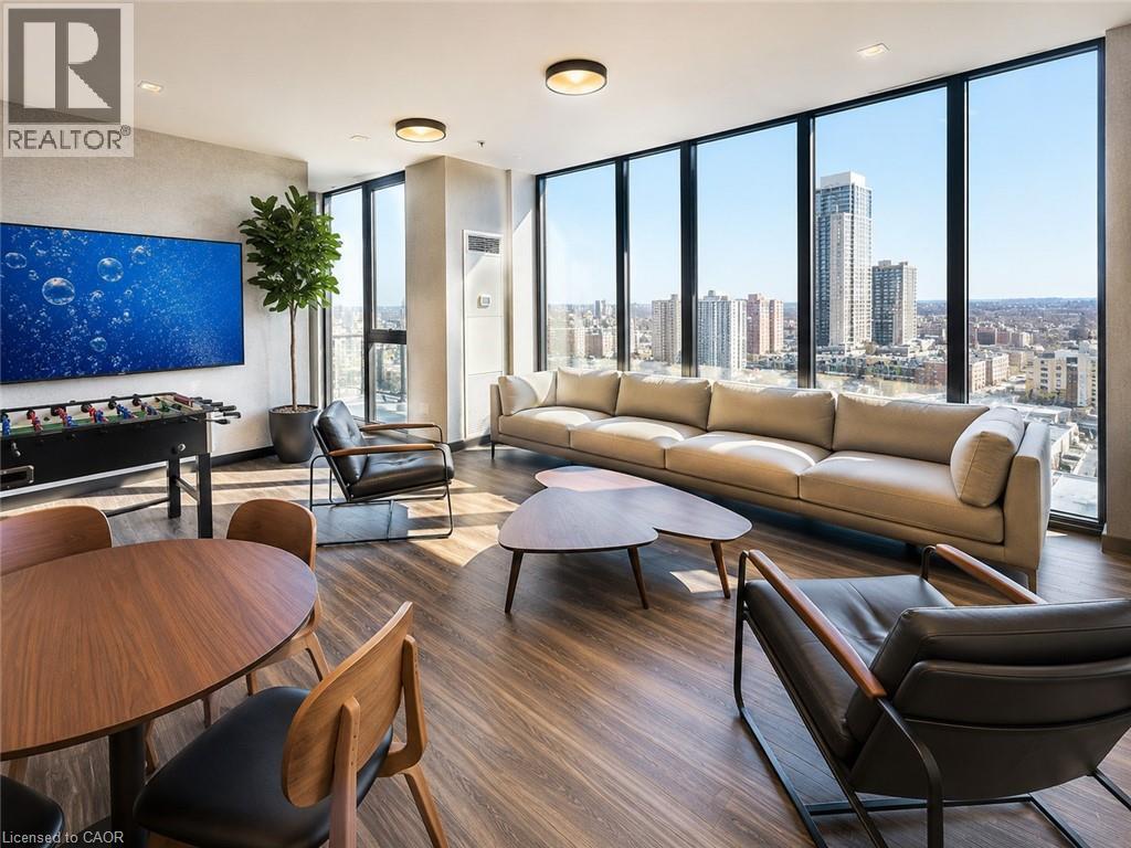 Expansive floor-to-ceiling windows featuring city architecture - 75 James Street S Unit# 2614, Hamilton, ON - Indoor Photo Showing Living Room