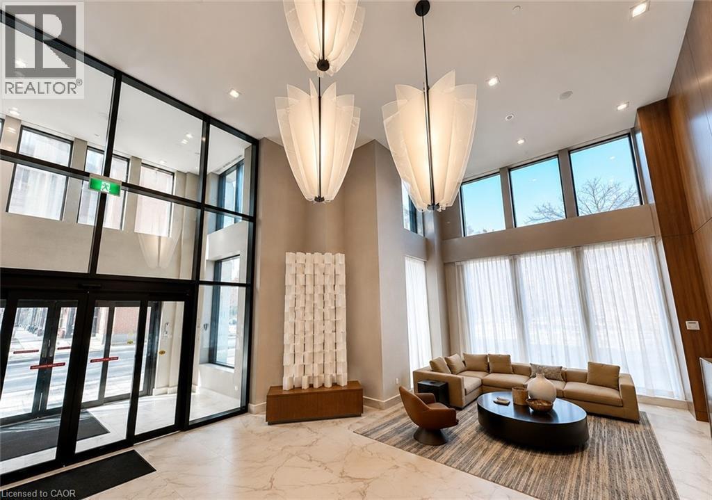Lobby area with high ceilings, marble flooring, and extensive window walls - 75 James Street S Unit# 2614, Hamilton, ON - Indoor Photo Showing Other Room