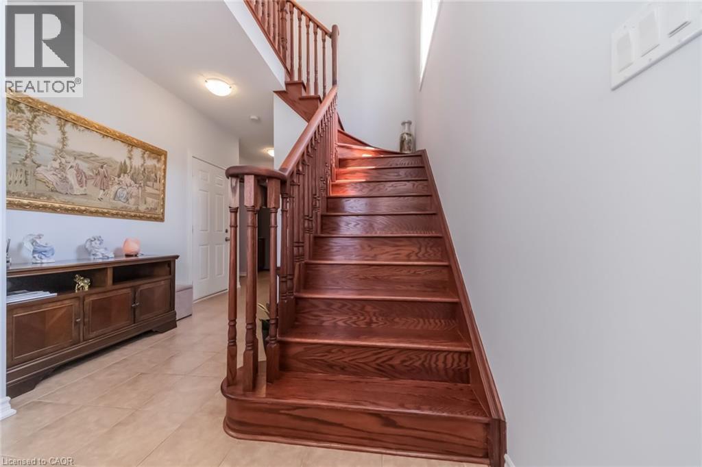Hardwood staircase with turned newel posts and balusters - 675 Best Road, Milton, ON - Indoor Photo Showing Other Room