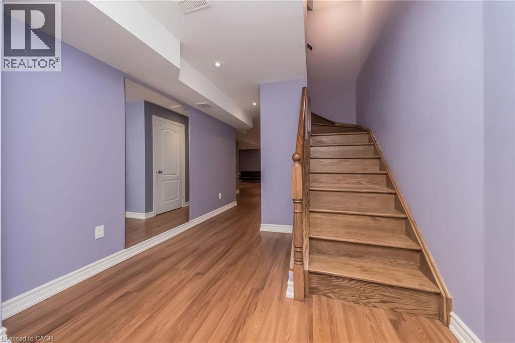 Hardwood flooring throughout the hallway and staircase - 675 Best Road, Milton, ON - Indoor Photo Showing Other Room