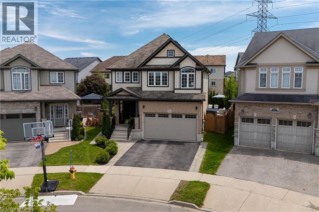 Contemporary two-story residence featuring a brick and siding exterior, an integrated two-car garage, and a covered front entry - 916 Steepleridge Court, Kitchener, ON - Outdoor With Facade