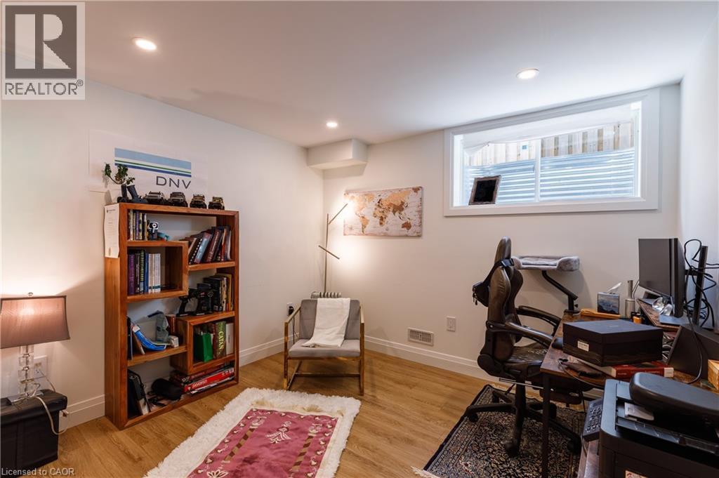 Versatile room featuring recessed ceiling lighting, a wood-finish flooring, and a window with white trim - 916 Steepleridge Court, Kitchener, ON - Indoor Photo Showing Office