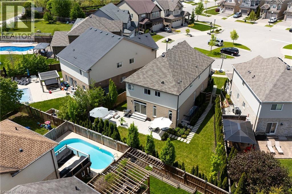 Contemporary residence featuring a light-toned brick and siding exterior with a dark shingle roof - 916 Steepleridge Court, Kitchener, ON - Outdoor