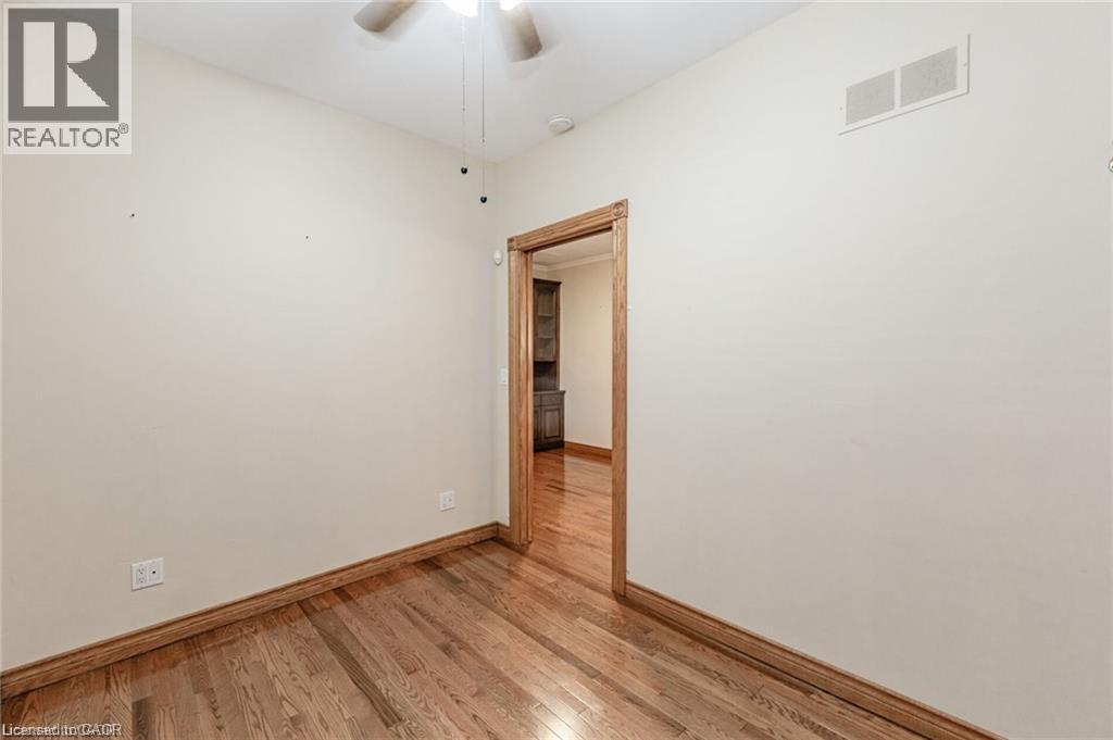 Hardwood flooring with coordinating wood trim and door frame - 252 Beechwood Avenue, Hamilton, ON - Indoor Photo Showing Other Room