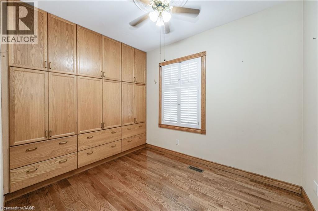 Built-in wood-finish cabinetry featuring multiple drawers and upper storage - 252 Beechwood Avenue, Hamilton, ON - Indoor Photo Showing Other Room