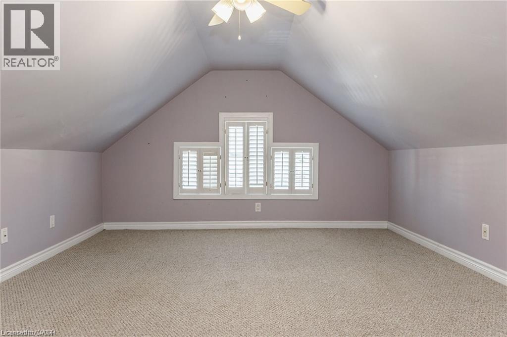 Room featuring sloped ceilings, neutral carpet flooring, and white baseboards - 252 Beechwood Avenue, Hamilton, ON - Indoor Photo Showing Other Room