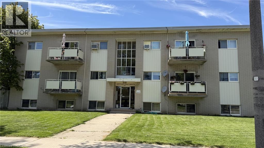 Three-story multi-family building with brick exterior and recessed balconies - 206 Indian Road, Kitchener, ON - Outdoor With Facade