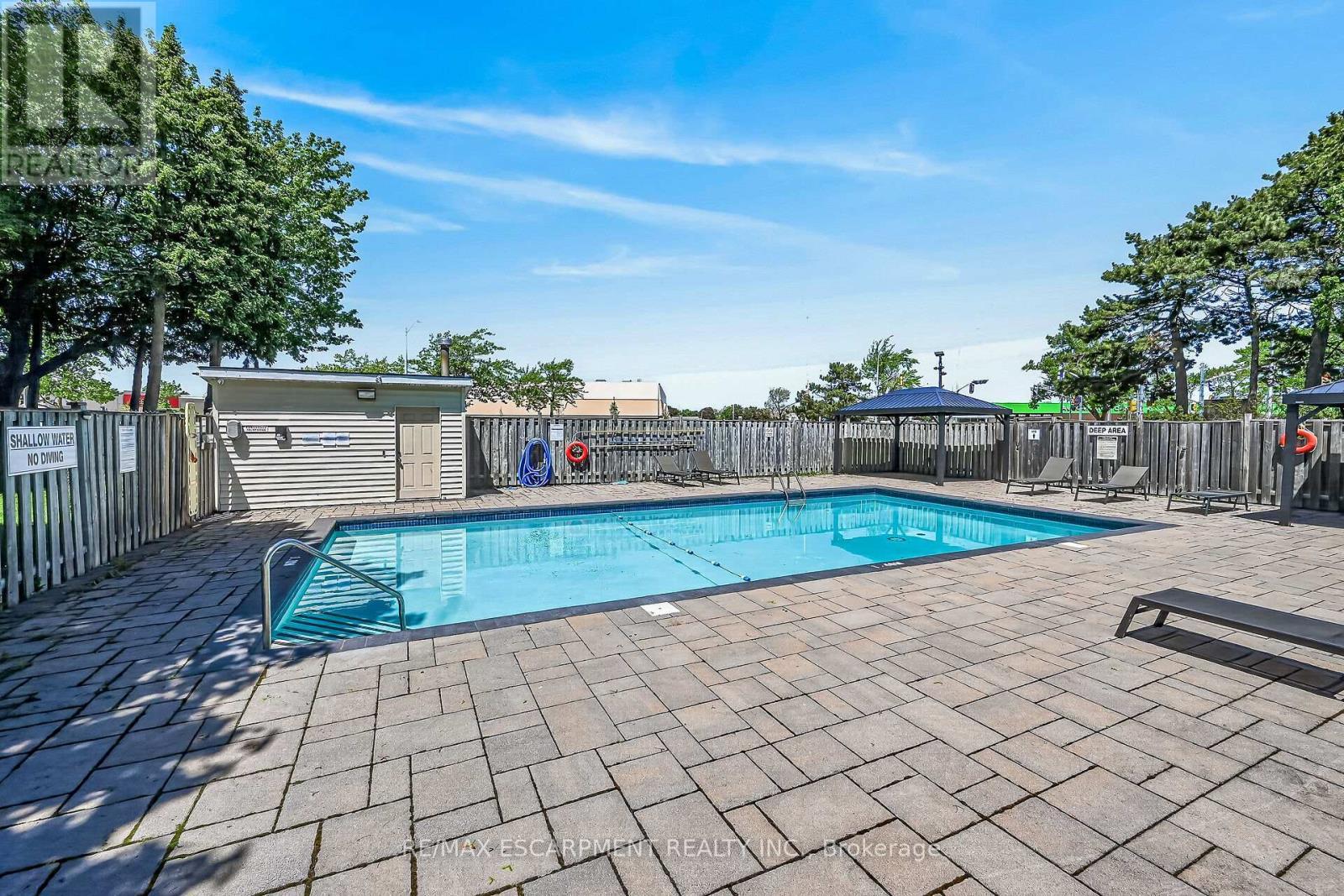 101 - 700 Dynes Road, Burlington, ON - Outdoor With In Ground Pool