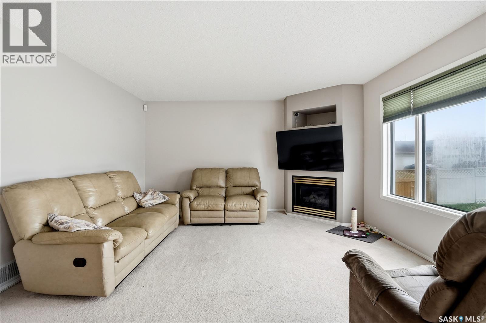 1204 Boehm Bay N, Regina, SK - Indoor Photo Showing Living Room With Fireplace