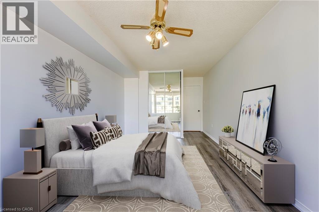Spacious room featuring wood-finish flooring, light neutral wall tones, and a ceiling fan with integrated lighting - 1270 Maple Crossing Boulevard Unit# 1705, Burlington, ON - Indoor Photo Showing Other Room