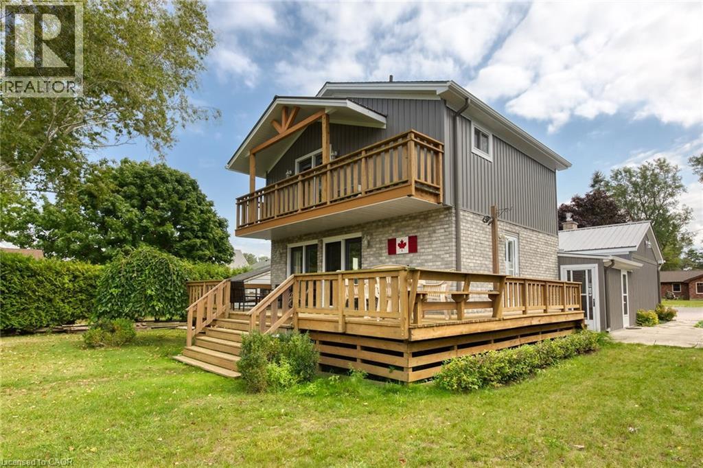 Multi-level residence featuring a spacious wooden deck with direct access to the yard - 270 Erie Boulevard, Long Point, ON - Outdoor With Deck Patio Veranda