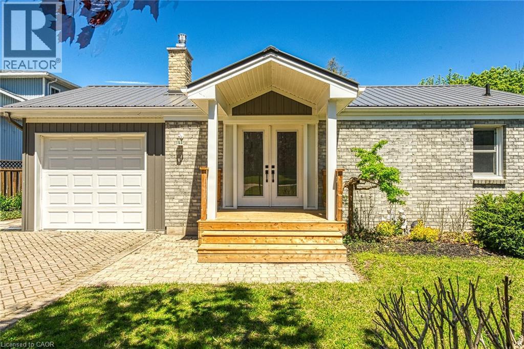 Front exterior showcasing light-toned brick facade with a prominent covered entry - 270 Erie Boulevard, Long Point, ON - Outdoor