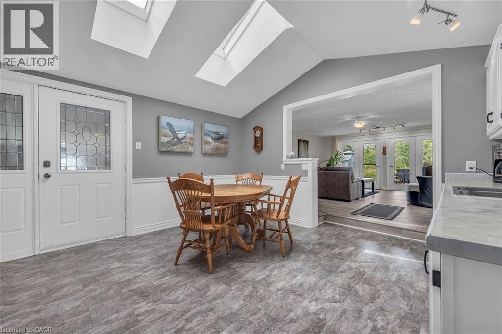 Vaulted ceiling dining area with skylights and wood-finish flooring - 270 Erie Boulevard, Long Point, ON - Indoor Photo Showing Dining Room