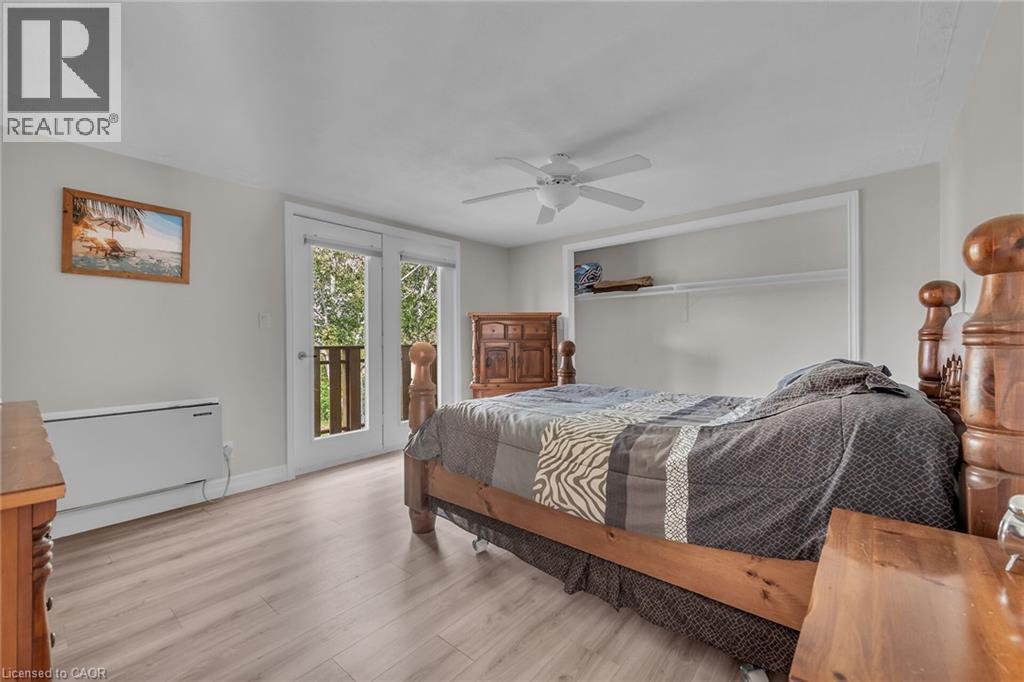 Room featuring light wood-finish flooring, a ceiling fan, and white walls - 270 Erie Boulevard, Long Point, ON - Indoor Photo Showing Bedroom