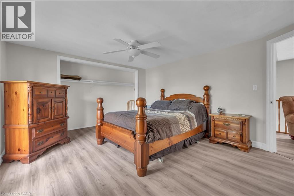 Spacious room featuring light wood-finish flooring, light gray wall paint, and a ceiling fan - 270 Erie Boulevard, Long Point, ON - Indoor Photo Showing Bedroom