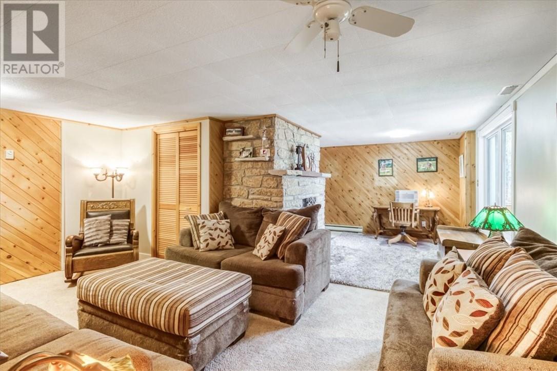 82A Pennie Avenue, Tehkummah, ON - Indoor Photo Showing Living Room With Fireplace