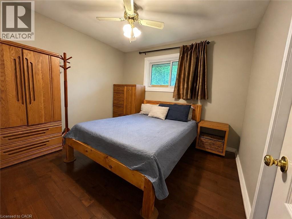 Warm wood-finish flooring complements neutral wall tones - 917 Orpha Street, Burlington, ON - Indoor Photo Showing Bedroom
