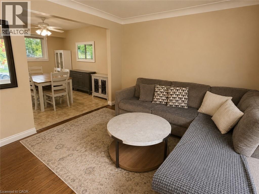 Living area featuring wood-finish flooring, neutral wall tones, and crown molding - 917 Orpha Street, Burlington, ON - Indoor