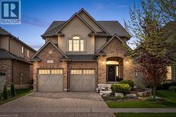 Traditional-style facade featuring brick and stucco elements. -