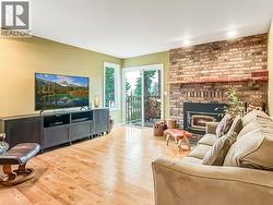 Inviting Second Living Area With Cozy Fireplace and Patio Access -