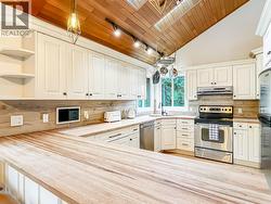 Bright Kitchen With Generous Counter Space And Skylights That Fill The Space With Natural Light -