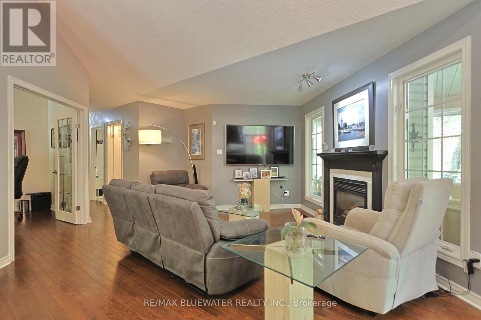 10419 Pinetree Drive, Lambton Shores (Grand Bend), ON - Indoor Photo Showing Living Room With Fireplace