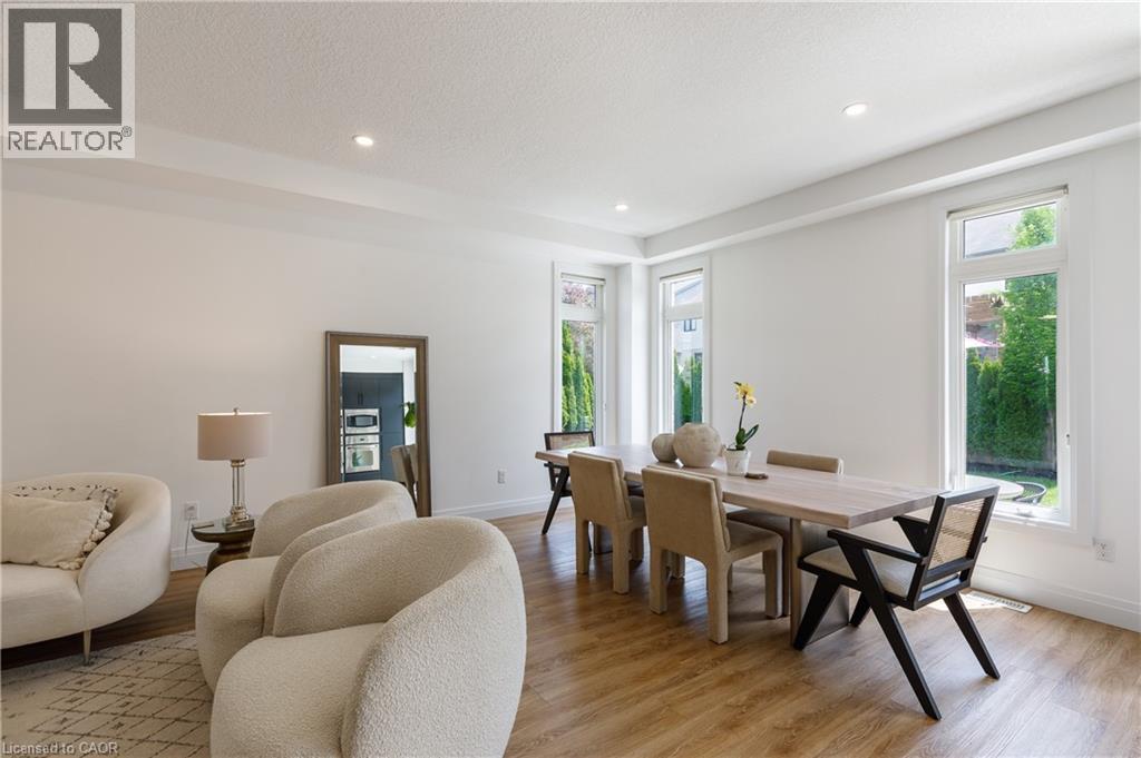Bright interior space featuring wood-finish flooring, recessed lighting, and multiple windows - 916 Steepleridge Court, Kitchener, ON - Indoor Photo Showing Living Room