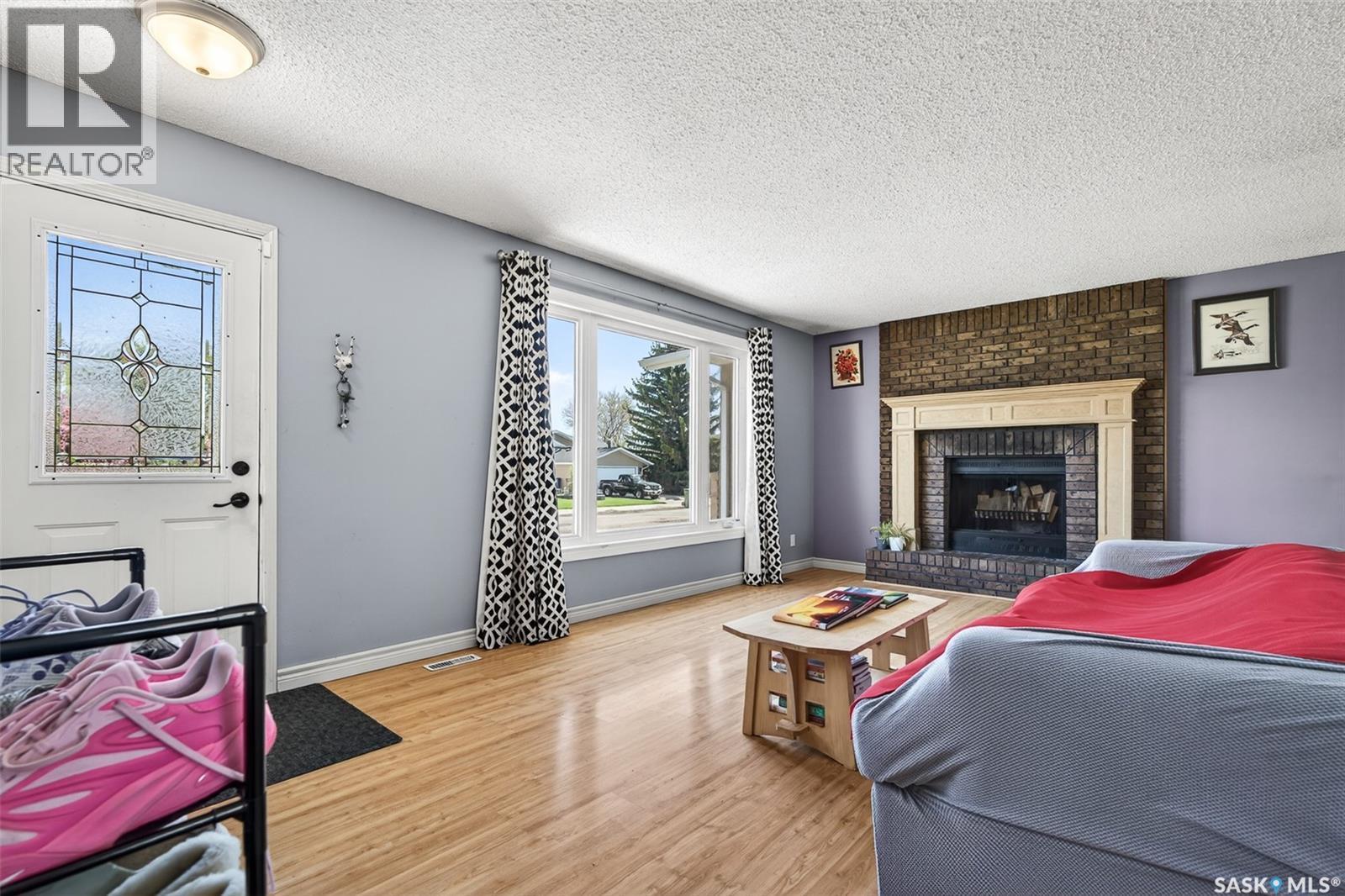 22 Edelweiss Crescent, Moose Jaw, SK - Indoor Photo Showing Living Room With Fireplace