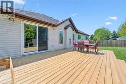 Expansive wood deck with a built-in step, offering direct access to the interior via a sliding glass door -