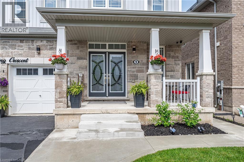 Stone facade with prominent covered porch and double entry doors - 9 Fleming Crescent, Caledonia, ON - Outdoor With Facade