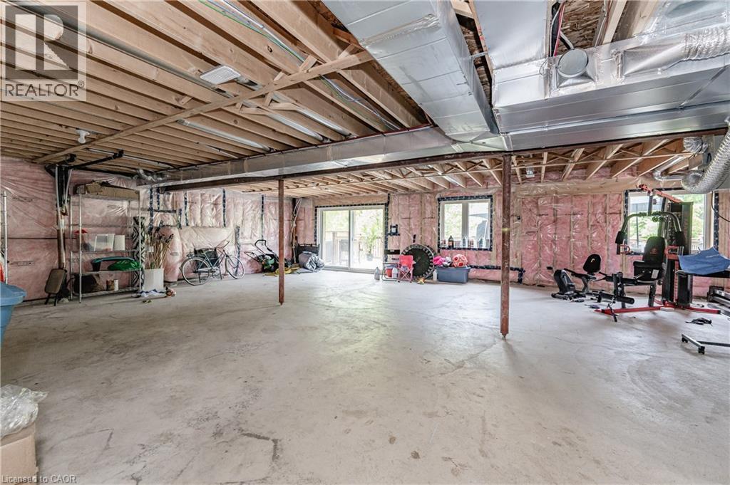 Spacious unfinished basement offering exposed wood joists, concrete flooring, and multiple windows - 9 Fleming Crescent, Caledonia, ON - Indoor