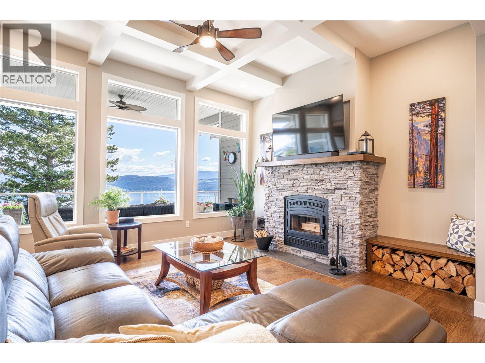 Living room with wood burning (WETT certified) fireplace - 132 Crown Crescent, Vernon, BC - Indoor Photo Showing Living Room With Fireplace