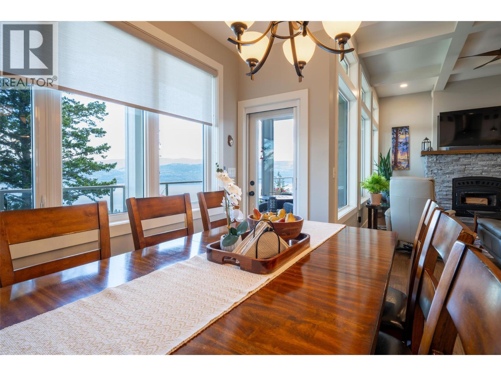Dining area and door to balcony - 132 Crown Crescent, Vernon, BC - Indoor Photo Showing Dining Room With Fireplace