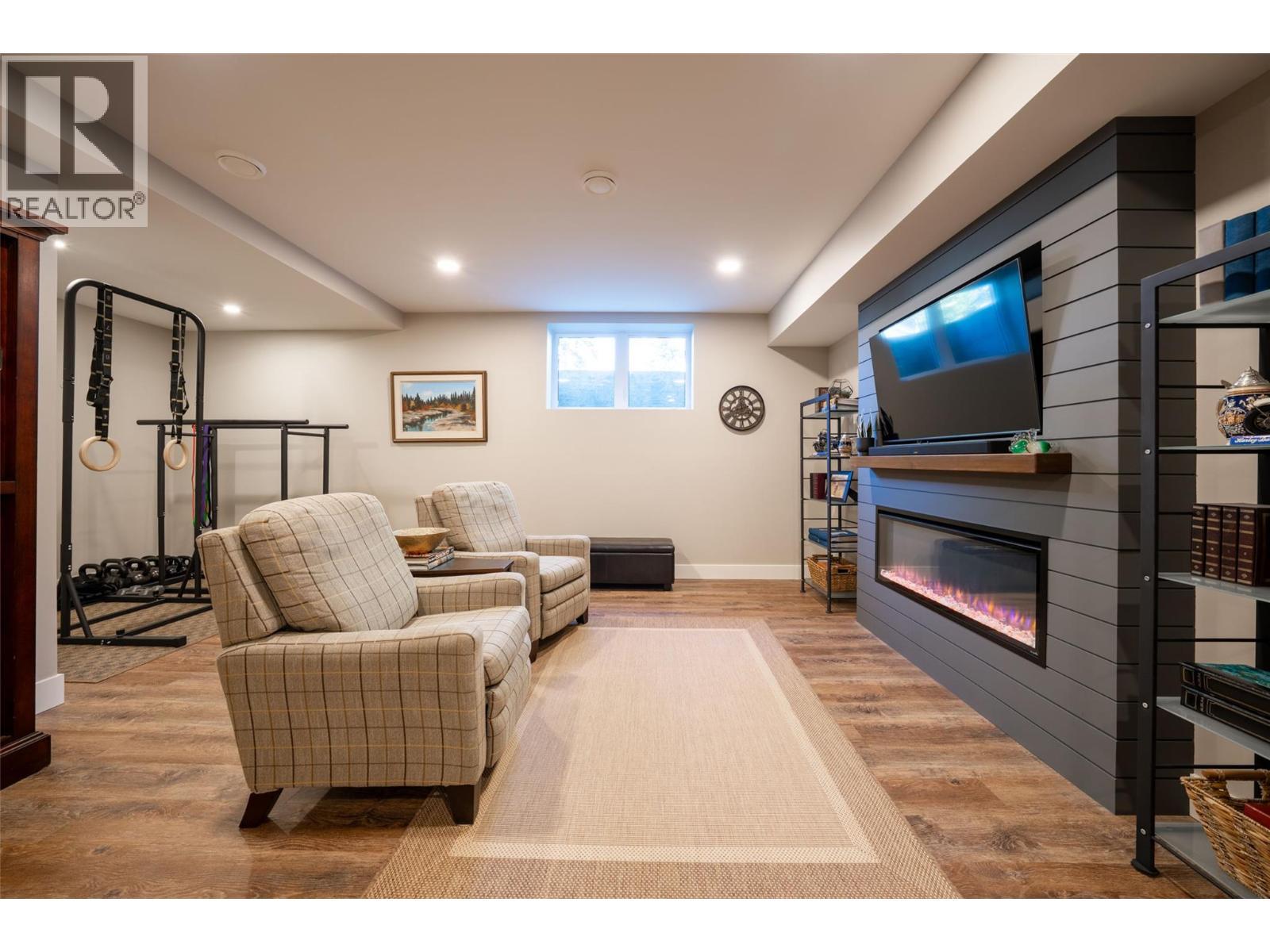 Basement family room - 132 Crown Crescent, Vernon, BC - Indoor Photo Showing Basement With Fireplace
