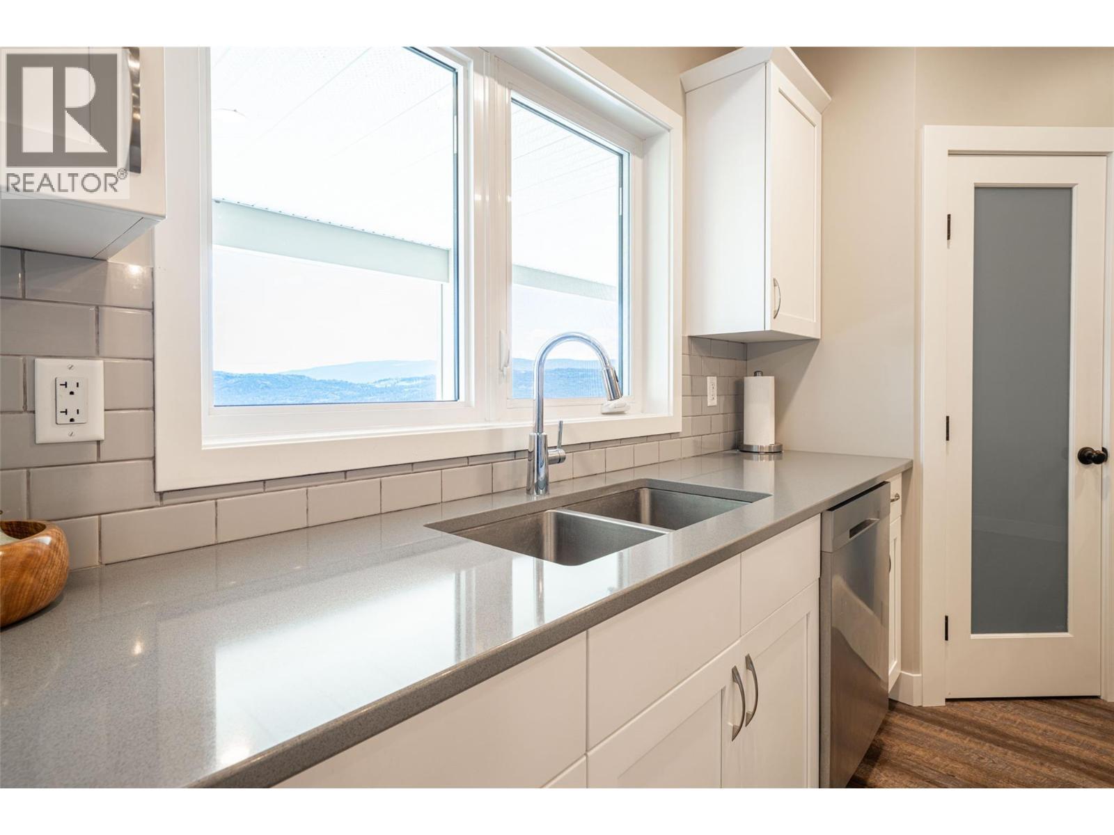 Basement suite built-in kitchen pantry - 132 Crown Crescent, Vernon, BC - Indoor Photo Showing Kitchen With Double Sink