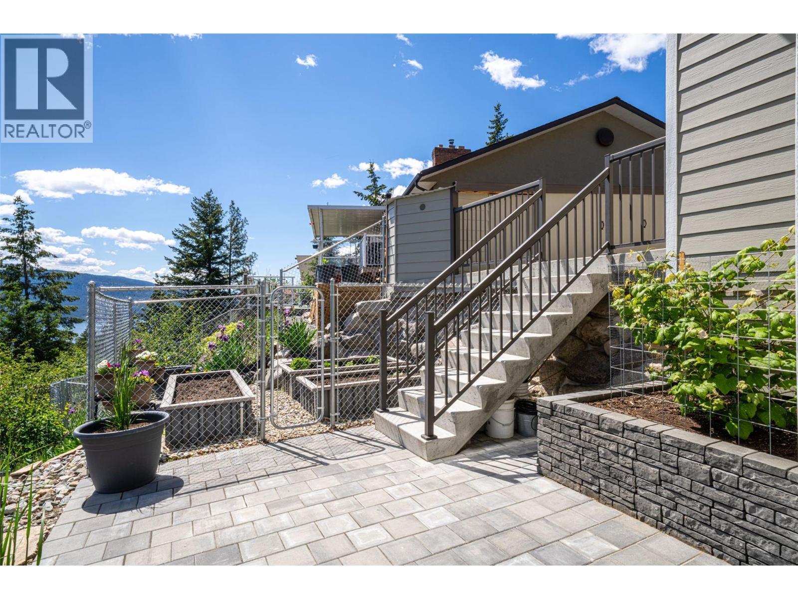 Side stairs and garden area - 132 Crown Crescent, Vernon, BC - Outdoor With Exterior