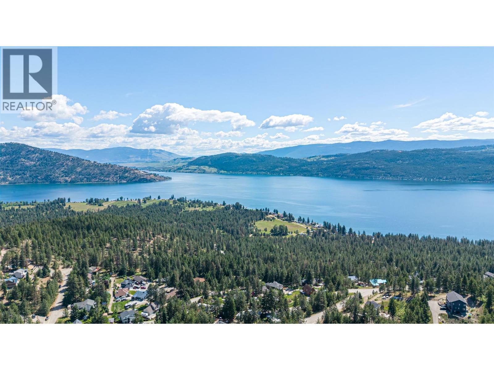 180-degree panoramic views of the Adventure Bay Peninsula and Sparkling Hill Resort - 132 Crown Crescent, Vernon, BC - Outdoor With Body Of Water With View