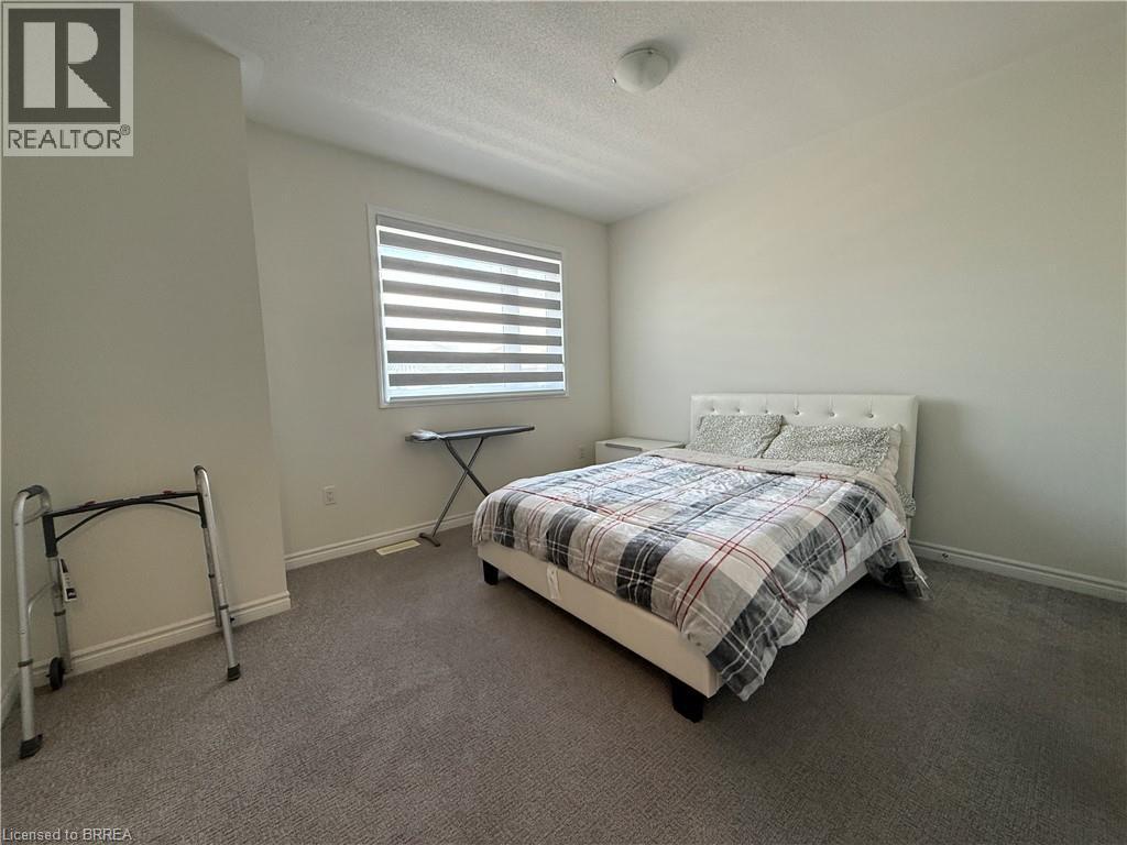 Carpeted interior space featuring a window with horizontal blinds, neutral wall paint, and a flush-mount ceiling light fixture - 18 Dolucci Crescent, Brampton, ON - Indoor Photo Showing Bedroom