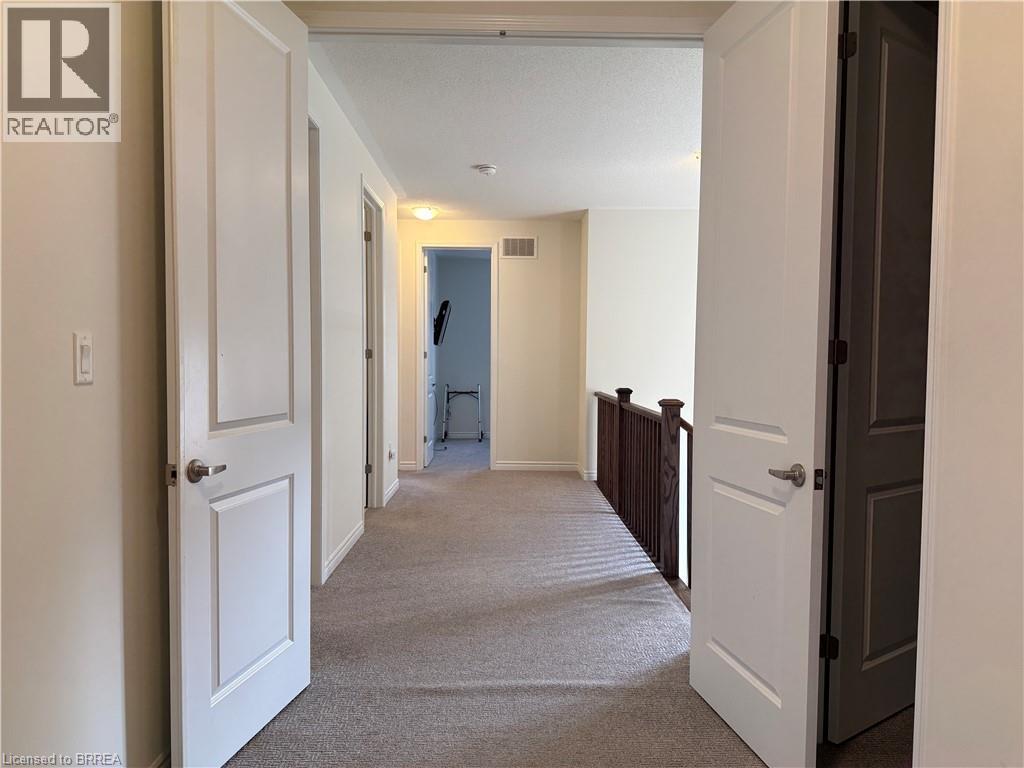 Carpeted hallway with painted walls and multiple panel doors - 18 Dolucci Crescent, Brampton, ON - Indoor Photo Showing Other Room