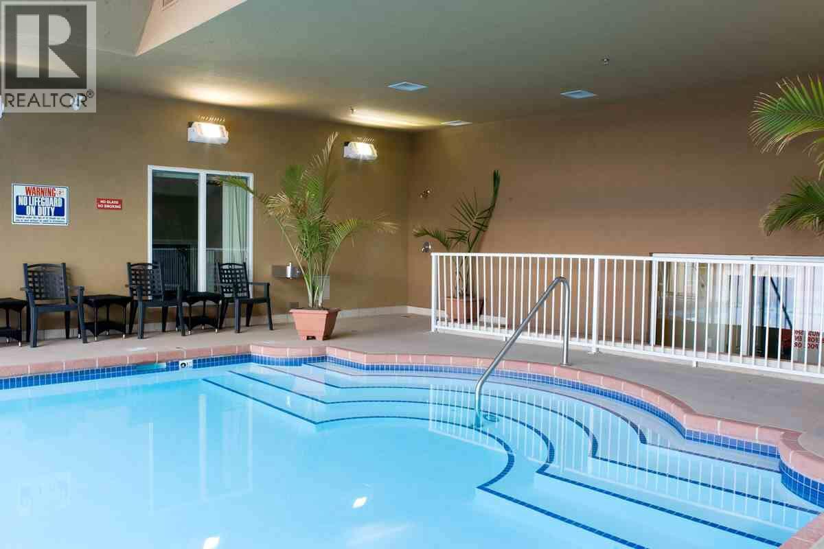 1088 Sunset Drive Unit# 635, Kelowna, BC - Indoor Photo Showing Other Room With In Ground Pool