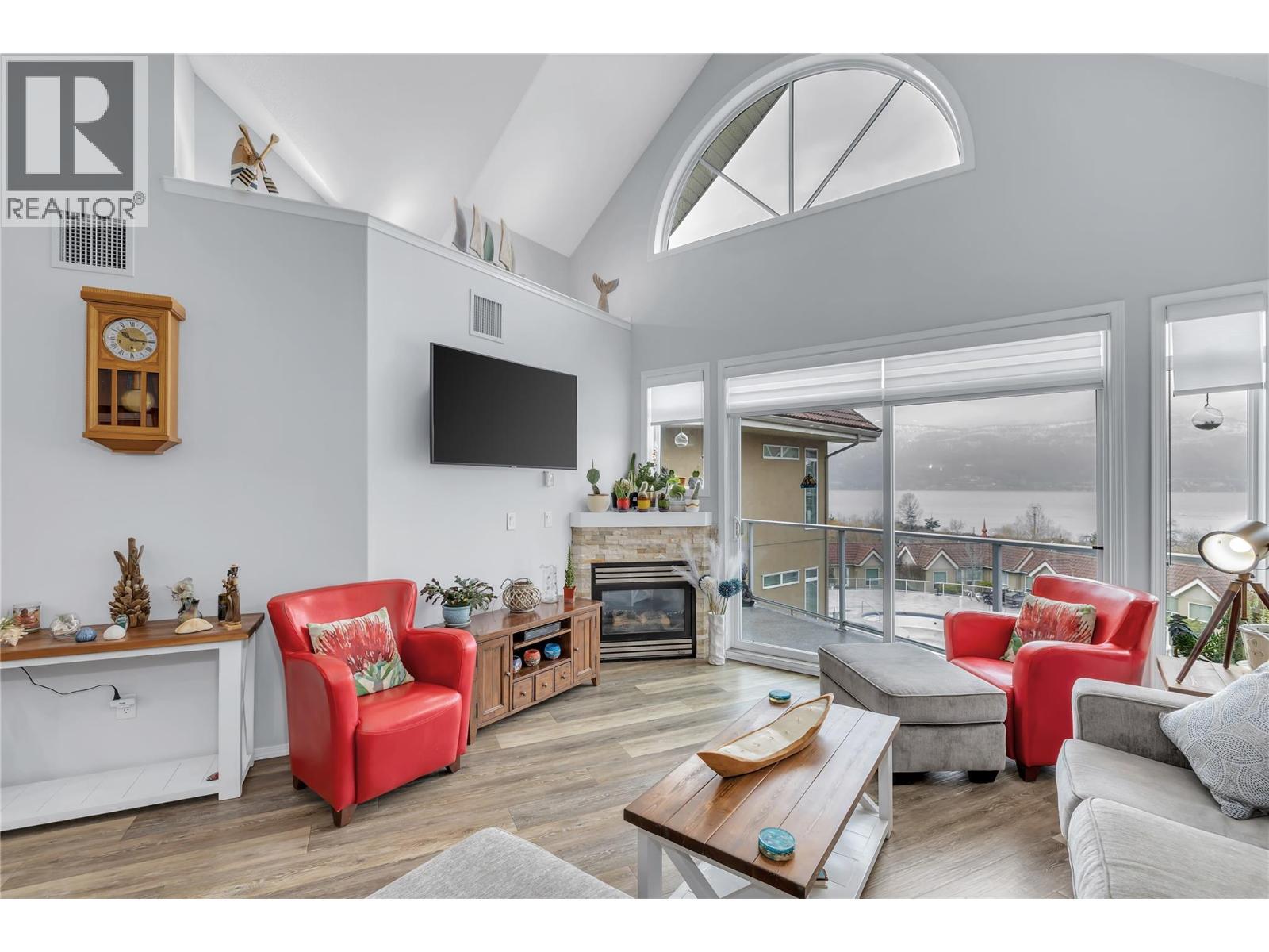 This photo has the owners furnishings but they have now been removed. - 1088 Sunset Drive Unit# 635, Kelowna, BC - Indoor Photo Showing Living Room With Fireplace