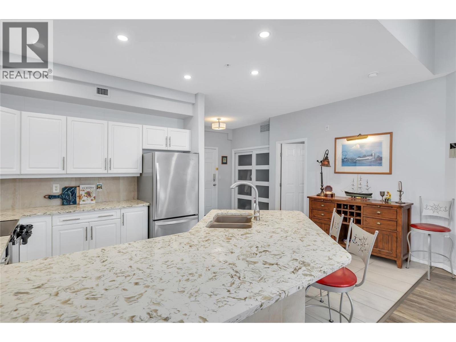 This photo has the owners furnishings but they have now been removed. - 1088 Sunset Drive Unit# 635, Kelowna, BC - Indoor Photo Showing Kitchen With Double Sink