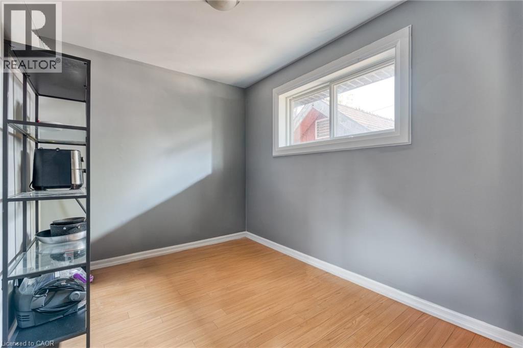Interior room featuring light gray walls, wood-finish flooring, and white baseboards - 151 Winchester Boulevard, Hamilton, ON - Indoor Photo Showing Other Room