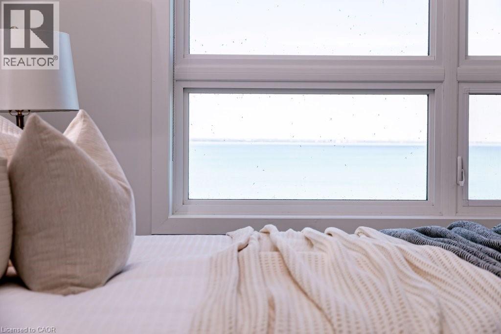 Expansive window framing a water backdrop - 101 Shoreview Place Unit# 631, Stoney Creek, ON - Indoor Photo Showing Bedroom